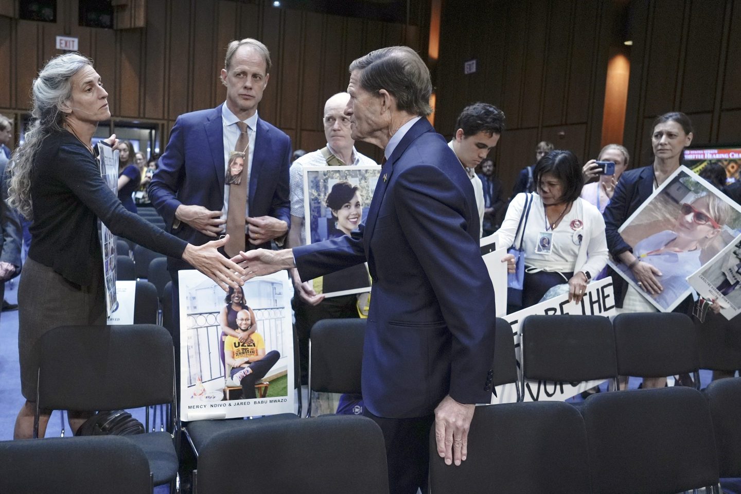 Sen. Richard Blumenthal, D-Conn., center, visits with family members of victims of Boeing plane crashes after a Senate Homeland Security Subcommittee on Investigations hearing on Capitol Hill Tuesday, June 18, 2024, in Washington. (AP Photo/Mariam Zuhaib)